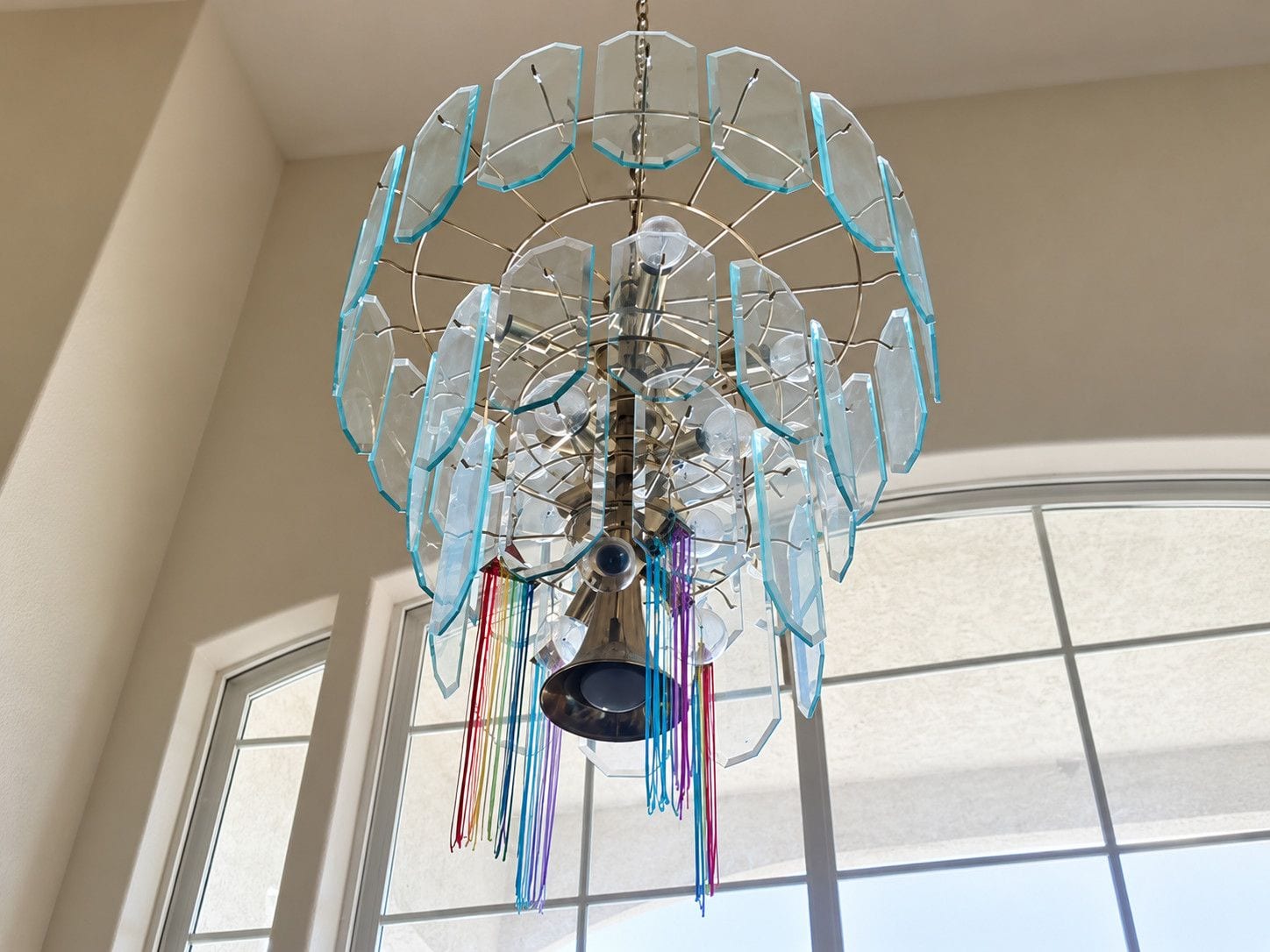 Decorative glass chandelier hanging above an entryway after cleaning