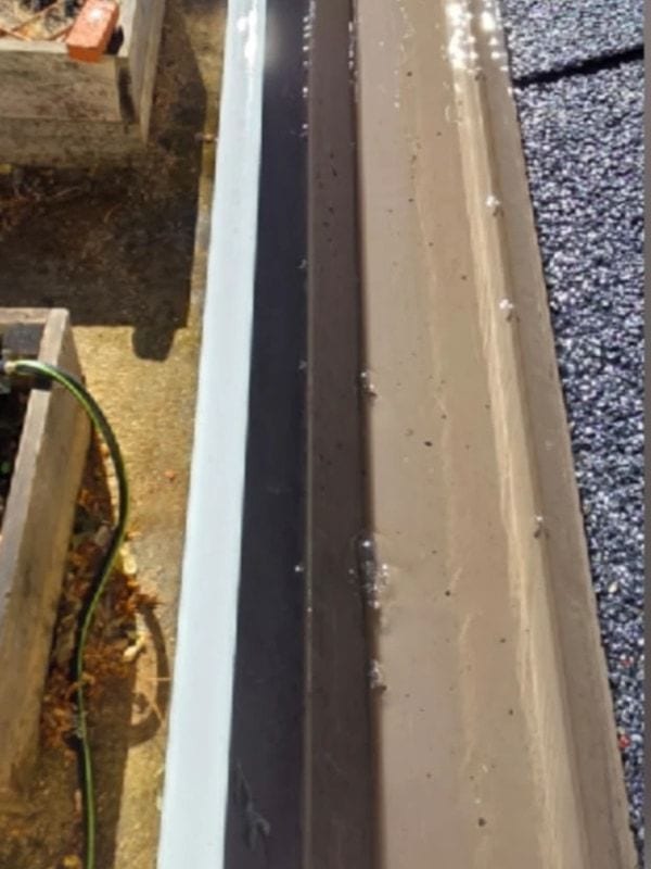 The same rain gutter seen from above after cleaning, clear of leaves and debris